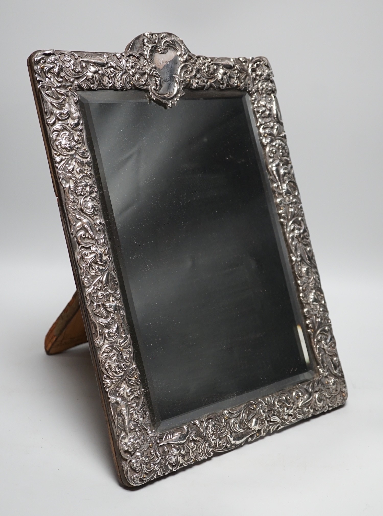 A late Victorian repousse silver mounted rectangular easel mirror, William Comyns, London, 1900, 39.8cm.